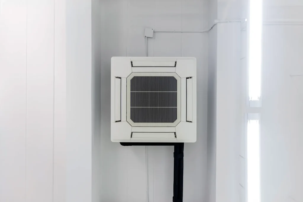 Four way ceiling mounted air conditioner in a room