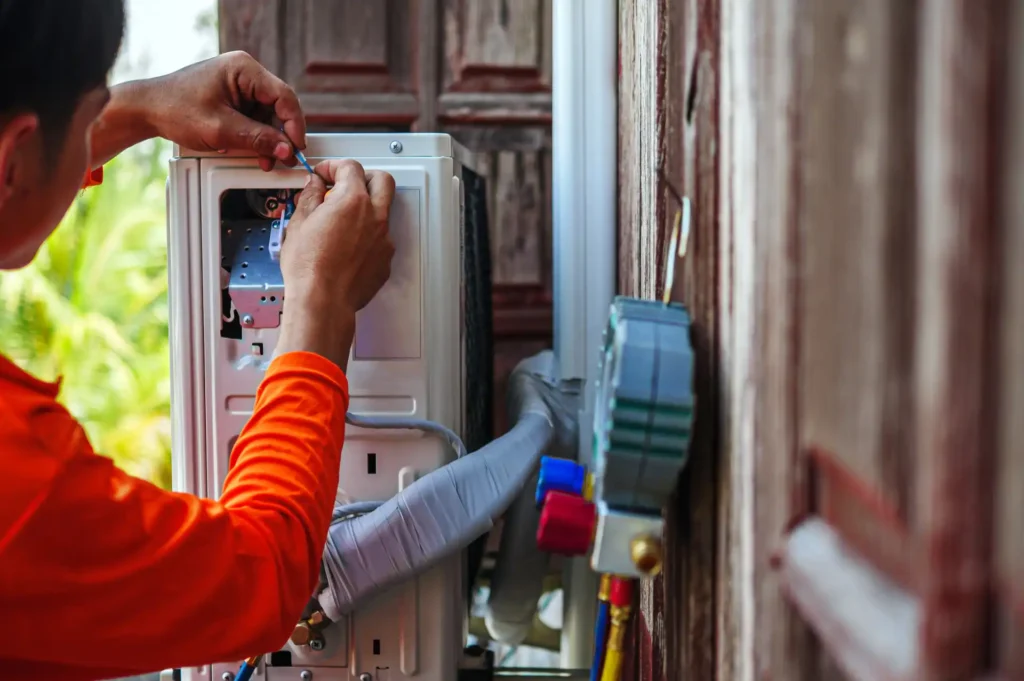 Technician repairing an air conditioner electrical control unit